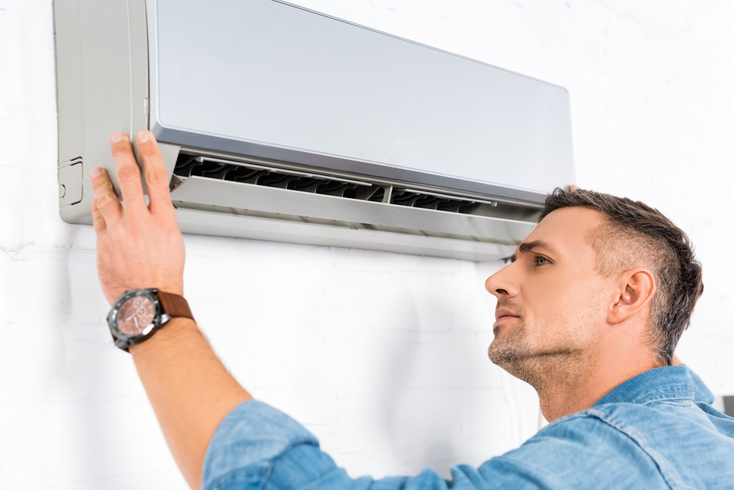 handsome adult man looking into air conditioner 2022 10 20 02 27 28 utc scaled 1